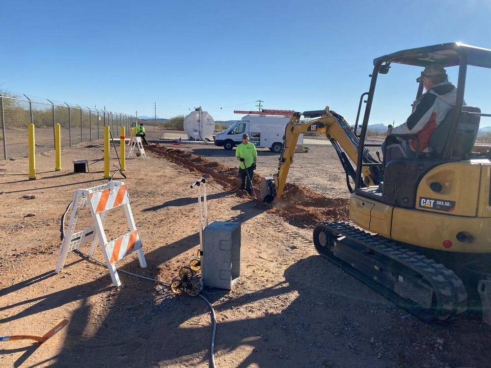 Cat excavator trenching for underground utilities, by Arizona Electrical Solutions